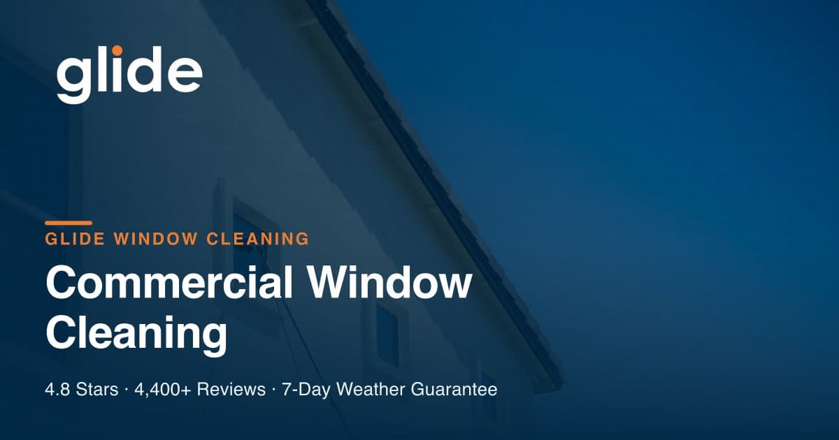 Professional cleaning the exterior glass of a commercial building