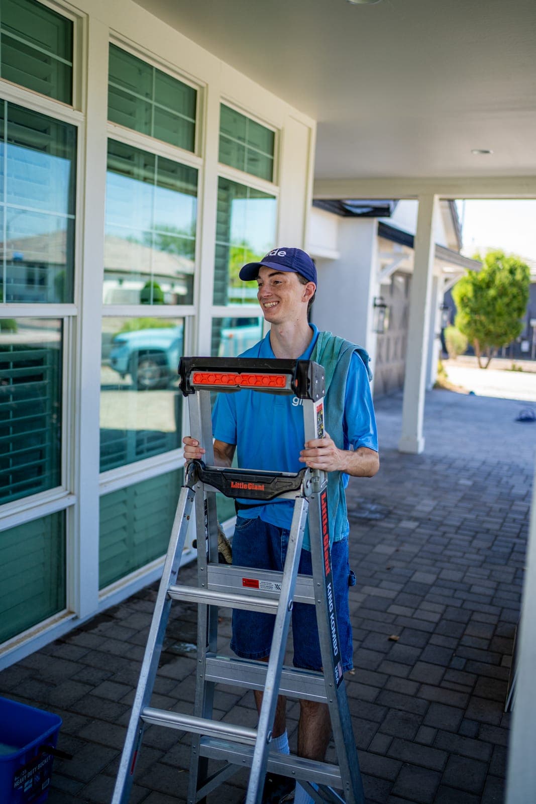 Glide technician setting up a ladder to clean exterior windows at a Phoenix-area home