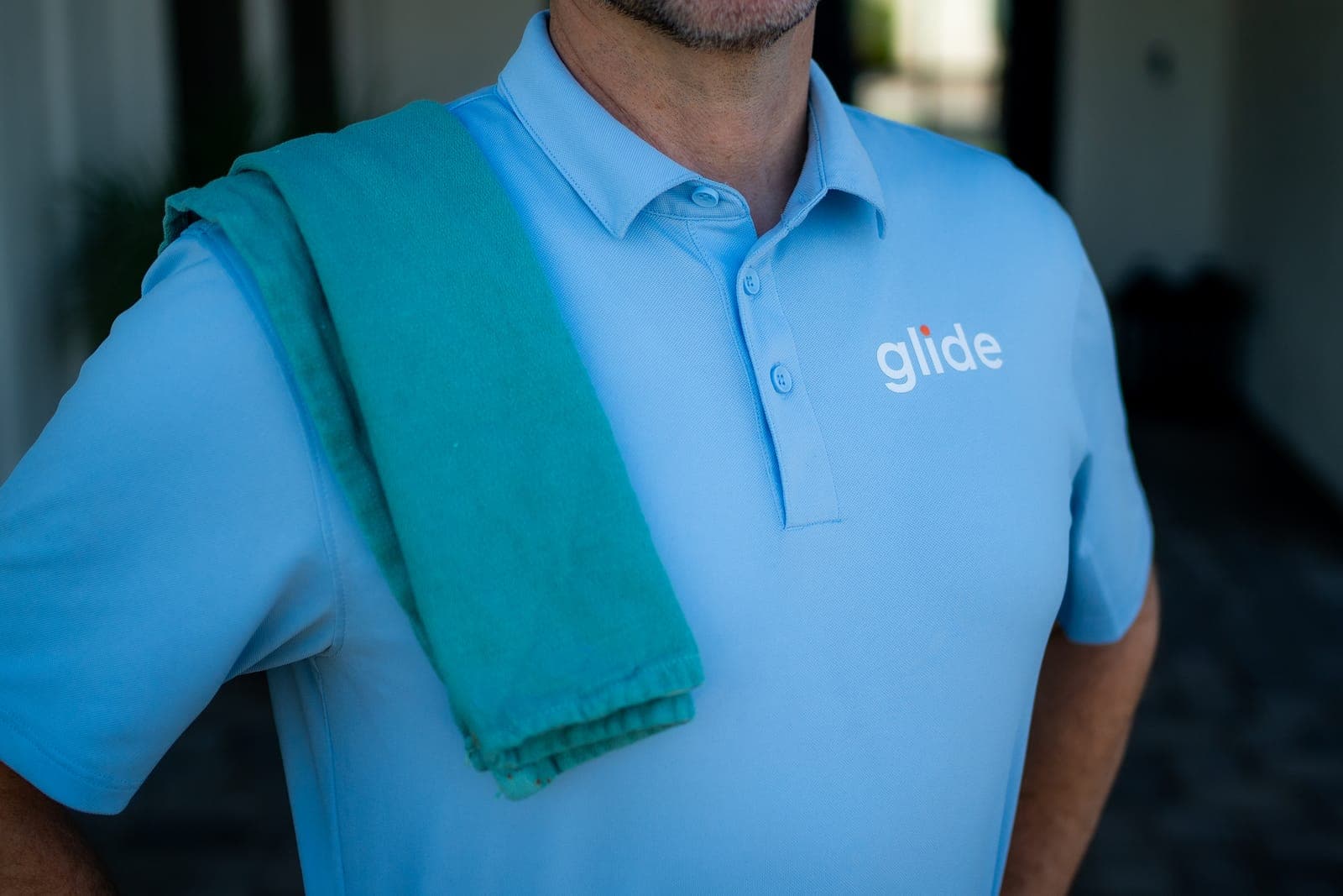 Glide Window Cleaning technician in uniform on a residential job